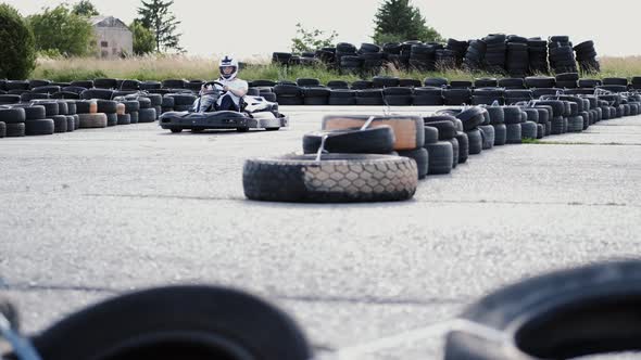 Male Racer in Protective Helmet Racing on the Go-kart Track Outdoors