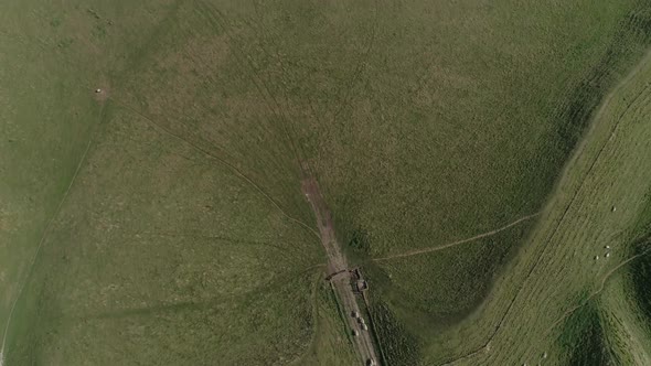 Aerial top down over the western gate ramparts of the iron age hill fort, Maiden Castle. Sheep can b