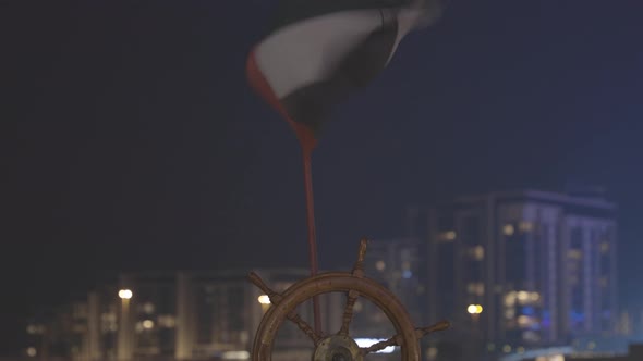 Flag of United Arab Emirates Against Background of Old Steering Wheel