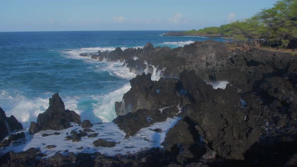 Waves crashing into shore on Hawaii