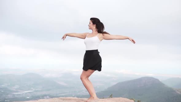 Graceful female dancing in countryside