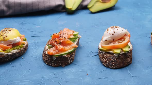 Healthy Food Concept. Open Sandwiches with Avocado on a Blue Table
