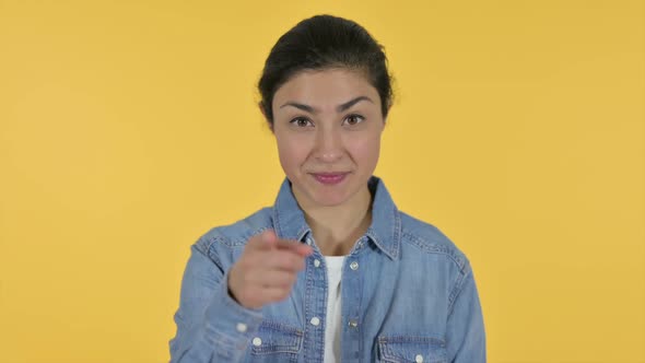 Indian Woman Pointing and Inviting Yellow Background