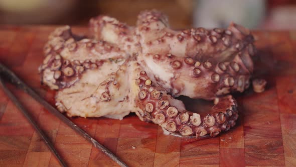 Close up dolly in and out shot of a cooked eight legged molluscs octopus with hot steam visibly appe