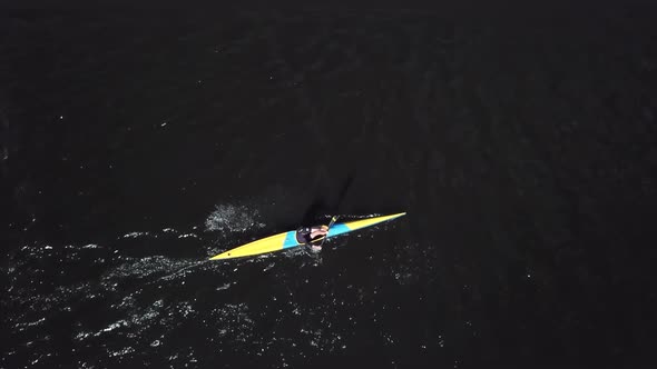 Sportsmen Kayaker Aerial View. Sportsman in Yellow Kayak Paddling on the River 