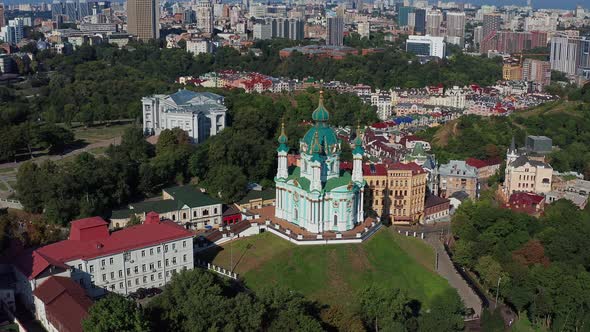 Beautiful flight over St. Andrew's Church in Kiev. Top view of Podol. Many buildings and churches.