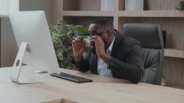 Entepreneur in His Office Looks Impressed and Delighted Showing Positive Emotions Looking at His