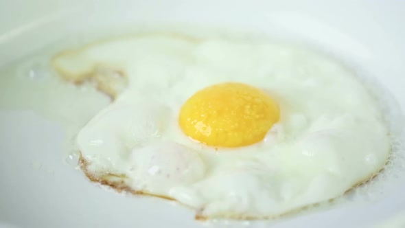 Frying sunny-side-up fresh farm egg.