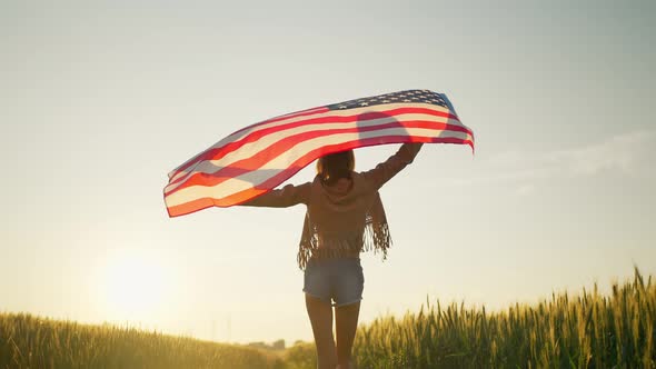 Slow Motion Beautiful Woman Walking with a USA Flag Outdoors at Sunset Rural Landmark