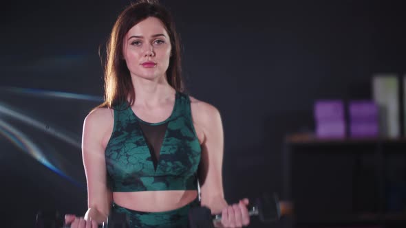 Young Pretty Woman Working Out Using Dumbbells