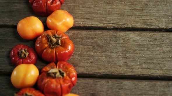 Small pumpkins and tomatoes on a wooden table 4k