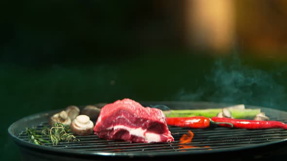 Super Slow Motion Shot Of Falling Fresh Beef Meat on Grill at 1000Fps