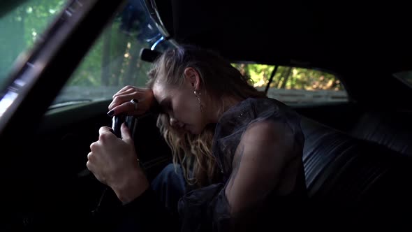 Suffering Woman Inside Car, Hugging Steering Wheel and Crying, Loneliness and Breakup, Sad Emotion