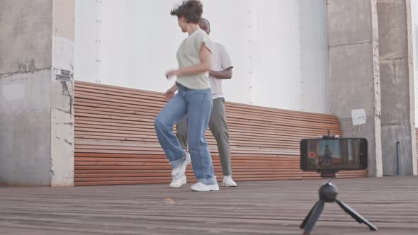 Diverse Couple Shooting Dance Videos on Smartphone