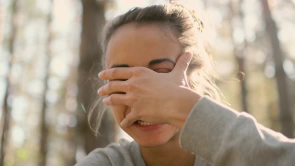 Close Up Happy Young Woman Laughs in Woods