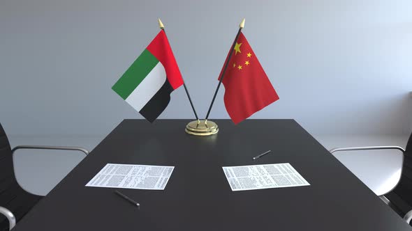 Flags of the United Arab Emirates and China on the Table