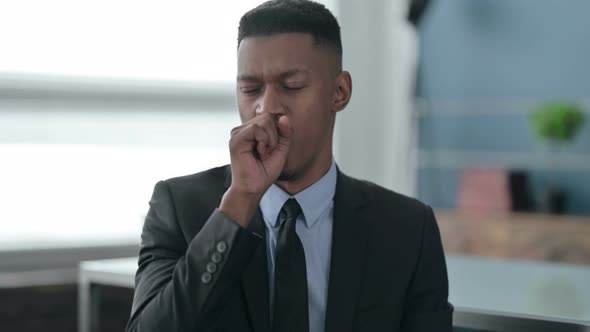 Portrait of Sick African Businessman Coughing