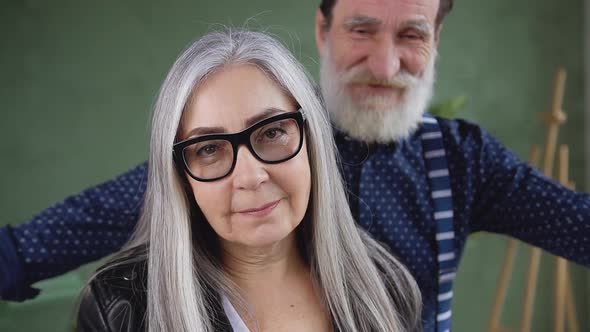 Woman and Bearded Smiling Man which Coming to Her and Hugging, Looking at Camera