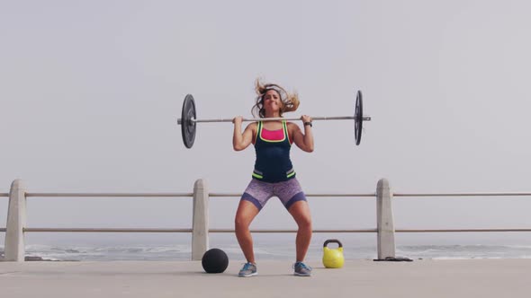 Caucasian woman working out on the docks