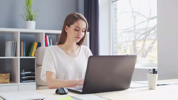 Young Woman Works at Home Office Using Computer.