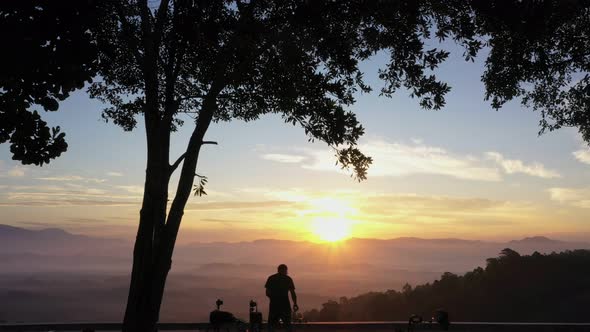 A Man Prepares The Equipment To Perform Photographing The Rising Sun.