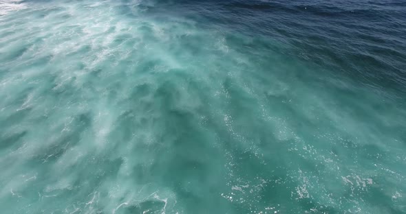 Aerial seascape view of blue ocean waves representing freedom and tranquility, background with copy