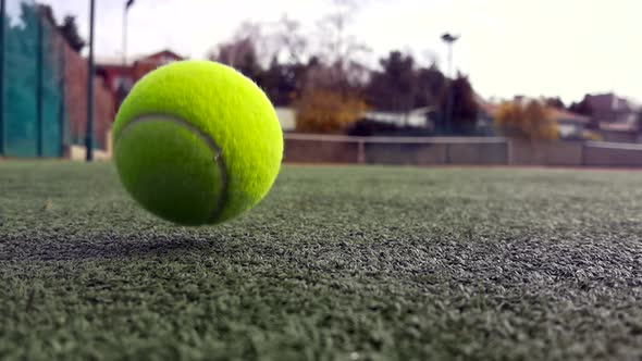 Yellow Tennis Balls in Super Slow Motion 1000 Fps on a Clay Green Court Next to the White Line with