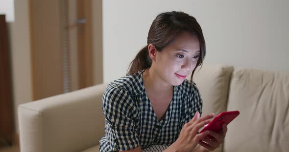 Woman use of smart phone at home in the evening