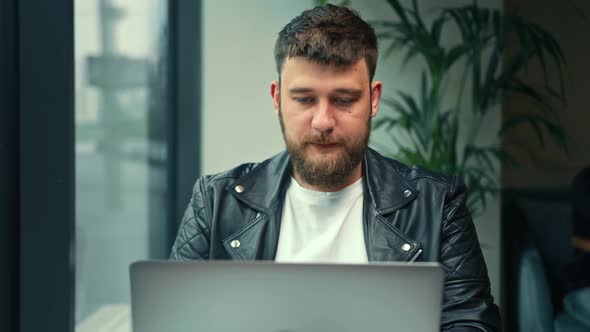 Young Caucasian business man zoom call on laptop in cafe. online education, freelance