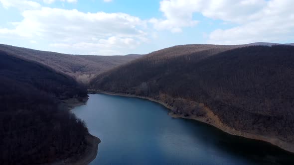 Above the blue lake on partly cloudy day