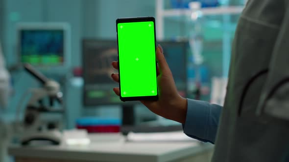 Chroma Key Isolated Display on Smartphone Used By Scientist Woman alt