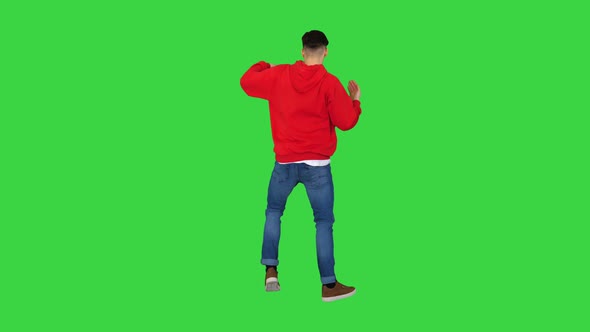 Young Man Dancing Hip-hop Doing Waves on a Green Screen, Chroma Key.