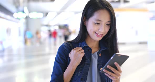 Woman use of mobile phone in station 