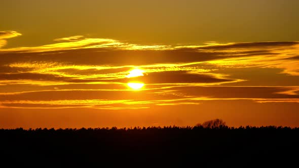 Sunset in the Sky Through Yellow Layered Clouds Timelapse