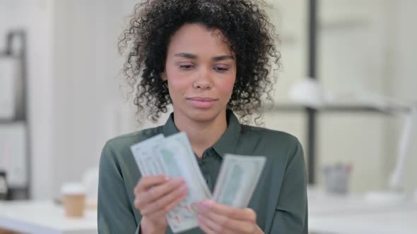 African Woman Counting Dollars