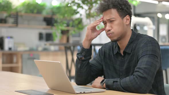 African American Man with Laptop Having Headache