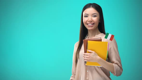 Cheerful Woman Holding Italian Flag Book, Education Abroad, Learning Language