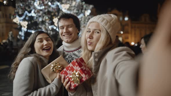 Happy Three Friends Taking Selfie at Xmas Night