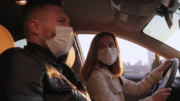 Couple in Masks Are Sitting in Car, There Is an Outbreak of Coronavirus in City