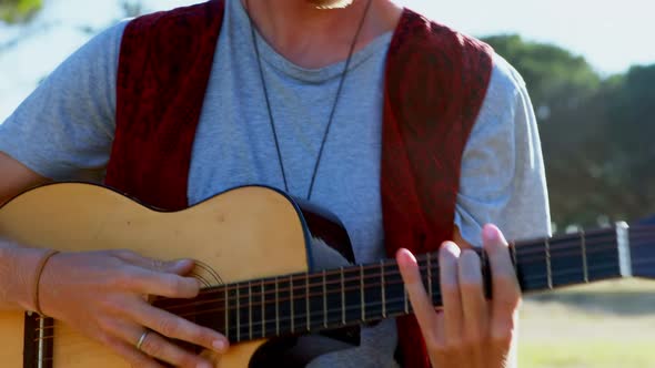 Man playing guitar at festival 4k