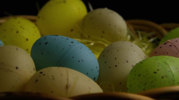 Rotating shot of Easter decorations and candy in colorful Easter grass