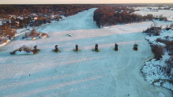 Fabulous Winter Landscape with a Frozen River at Sunset Aerial View