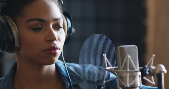 Sound Record Industry. African American Female Singer Recording New Song at Professional Room