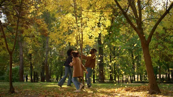 Happy Family Play Park Run Under Falling Golden Leaves