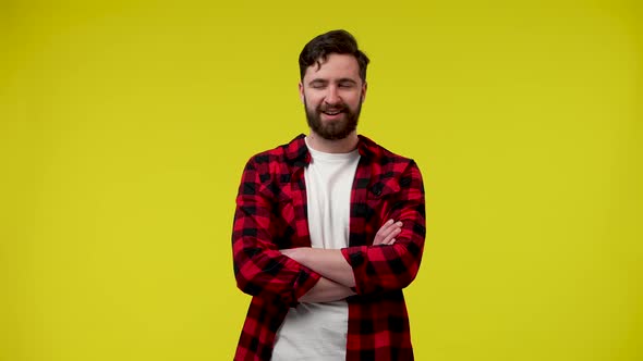 Portrait of a Stylish Bearded Man in the Studio on a Yellow Background