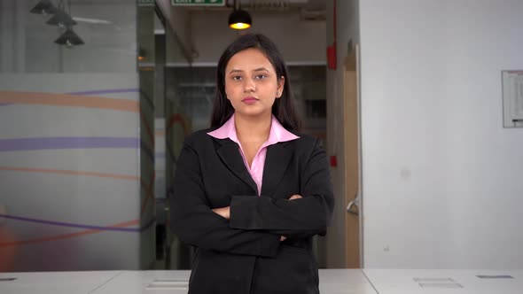 Confident Female Indian entrepreneur standing crossed hands