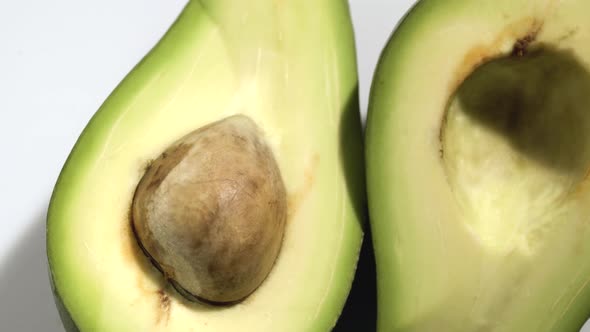 Avocado Slices Closeup, Macro Food Summer Background, Fruits Top View. Rotate