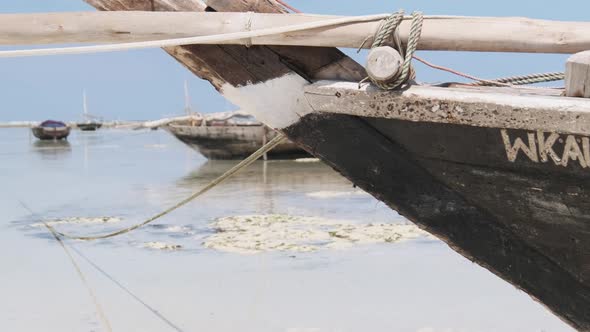 African Traditional Wooden Boat Stranded in Sand on Beach at Low Tide Zanzibar