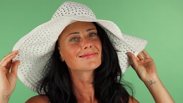 Attractive Woman Smiling To the Camera Wearing White Hat