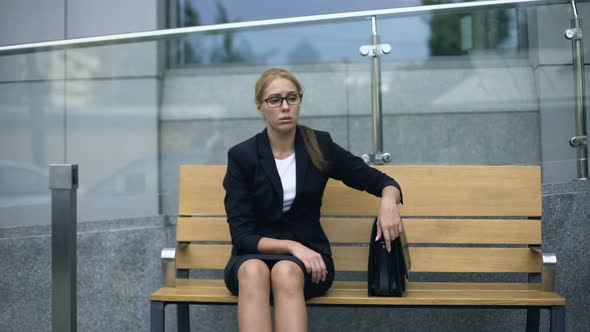 Frustrated Office Employee Sitting on Bench, Tired After Stressful Meeting